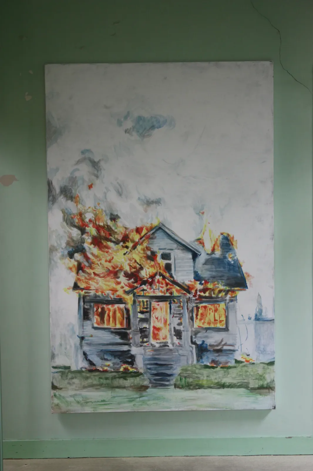 Maison en feu, Installation view. The canvas hung on a pale green wall.